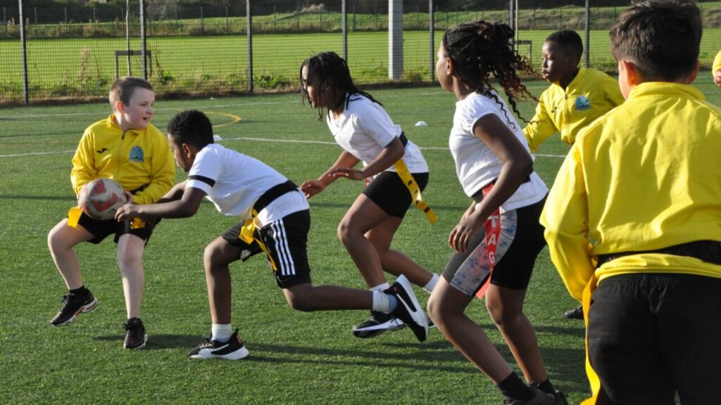 Children playing tag rugby