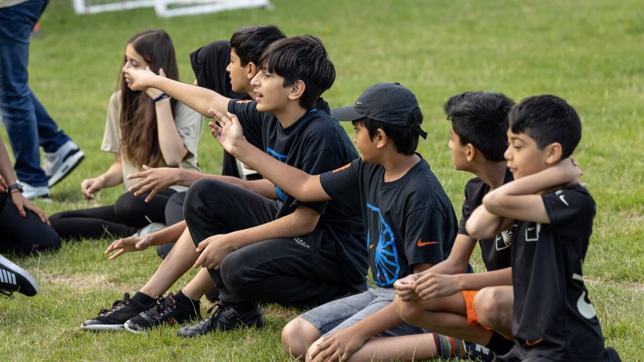 Students sat down cheering on teams