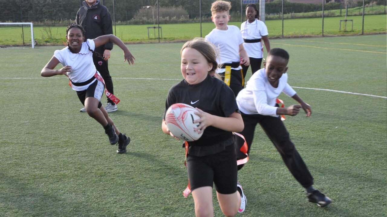 Pupils playing tag rugby